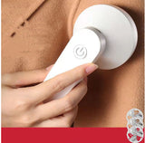 USB Rechargeable Lint Remover being used on fabric to remove lint and hair balls, showcasing its practical design.